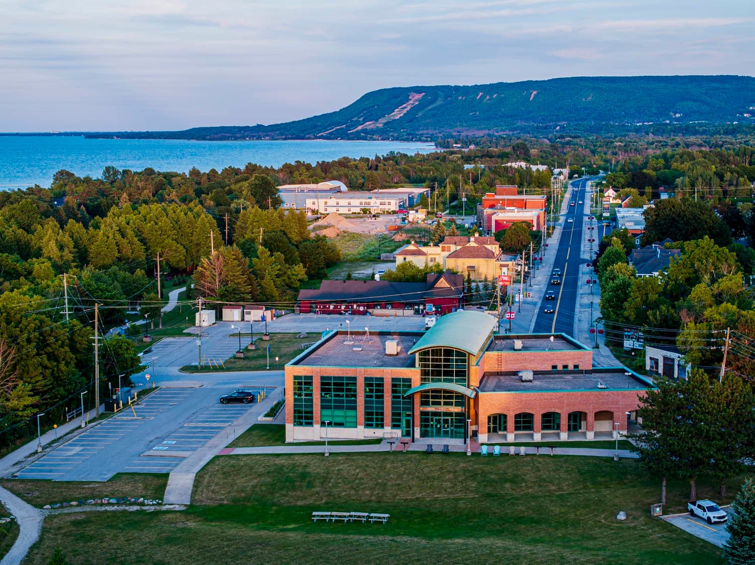 Main street and waterfront at dusk with the ski hills behind