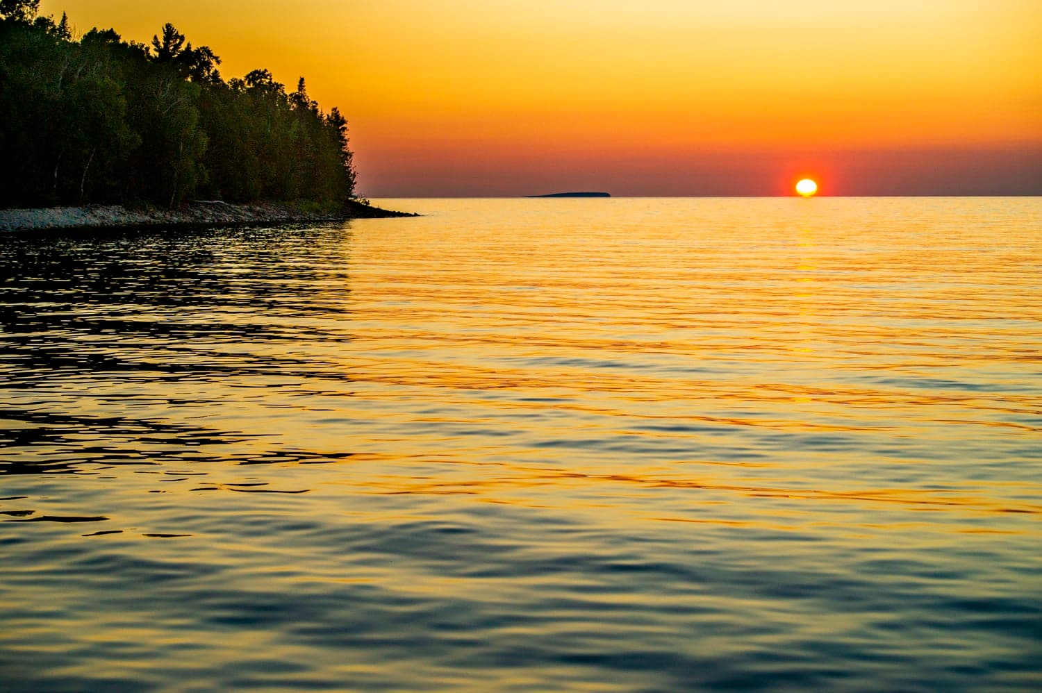 Sunset silhouette of a small island offshore