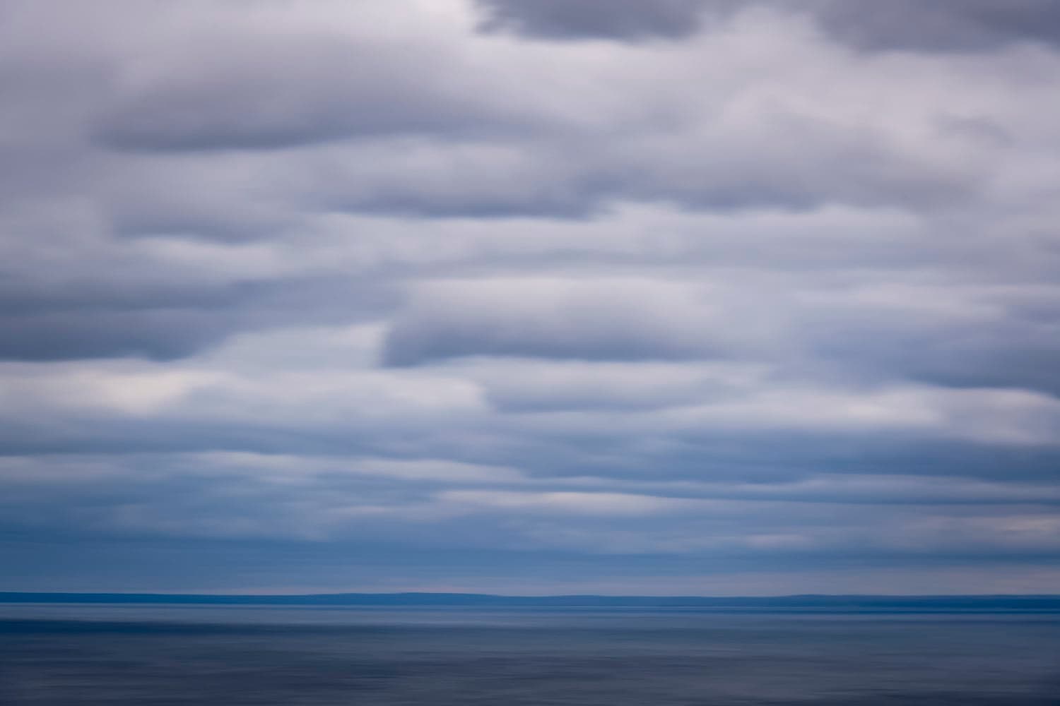 Moody storm clouds over calm open water