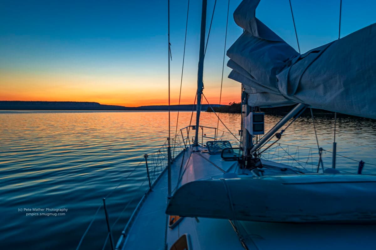 From the foredeck of a sailboat at sunset on the bay