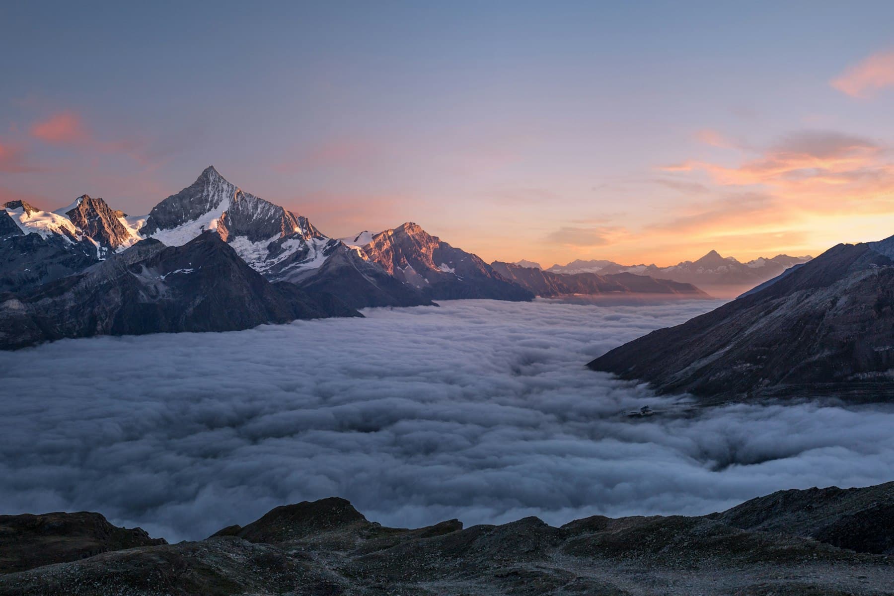Ridgeline above low cloud at sunrise