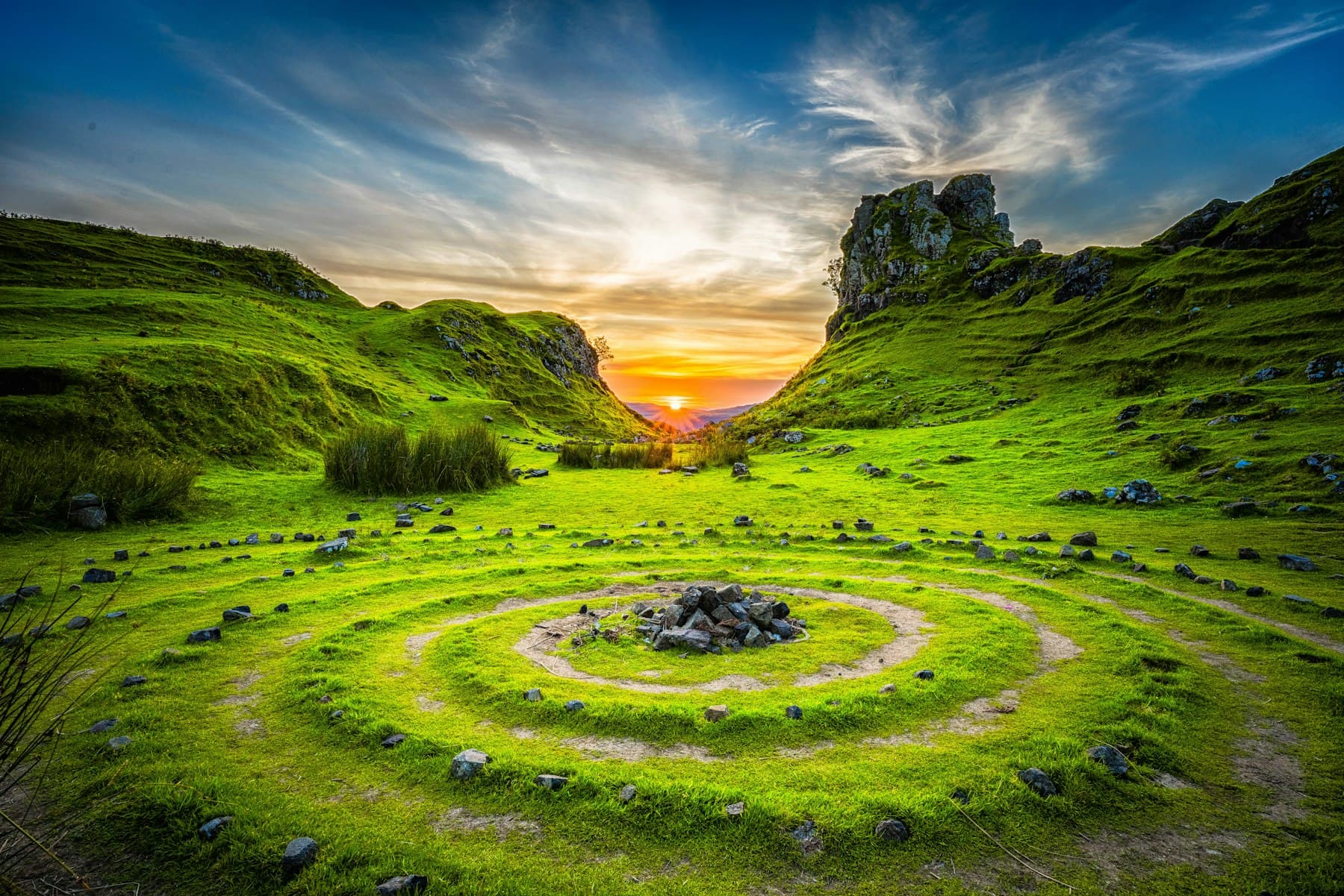 Sun setting over green hills
