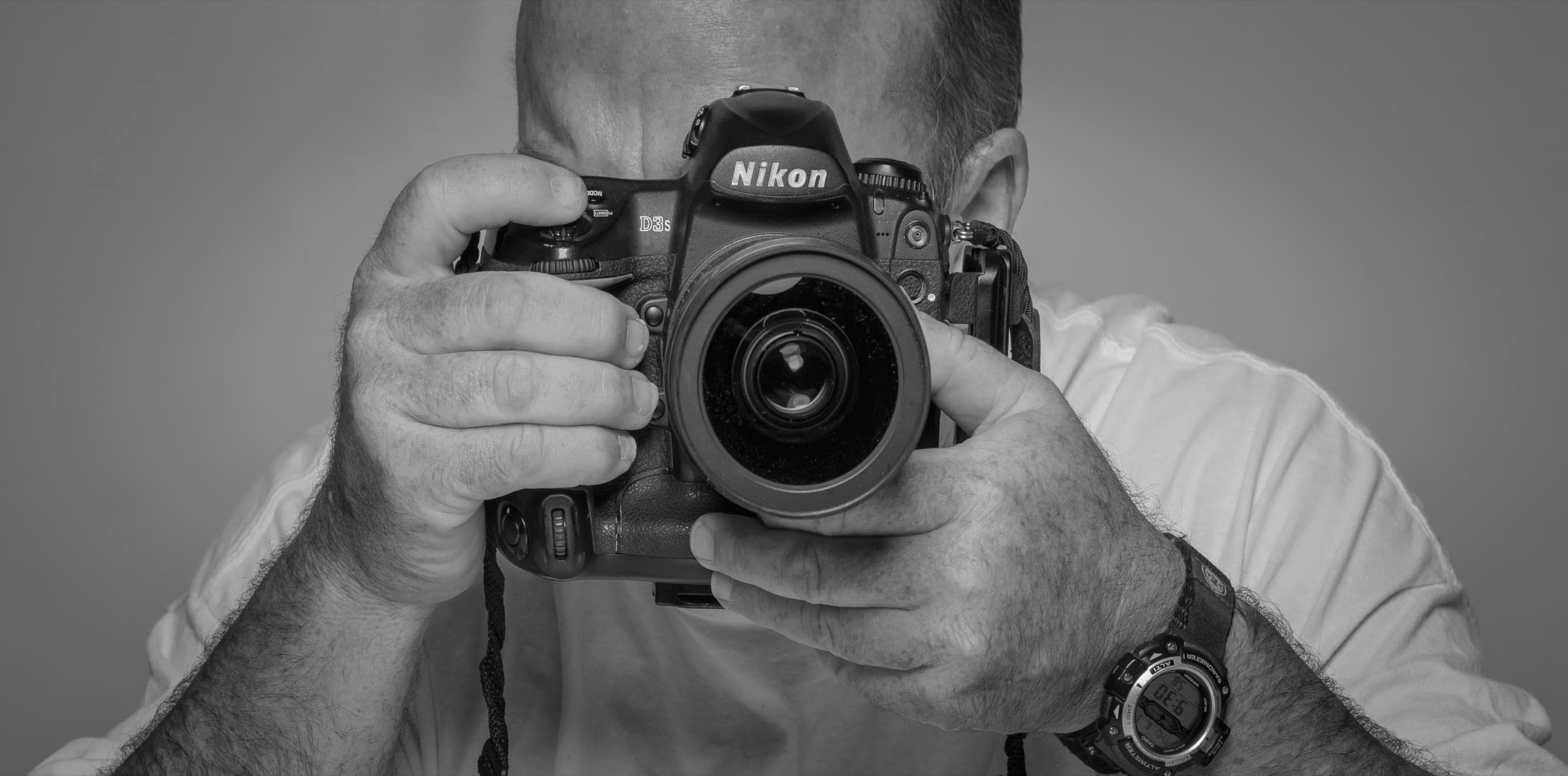 Pete Mather holding a Nikon camera to his eye