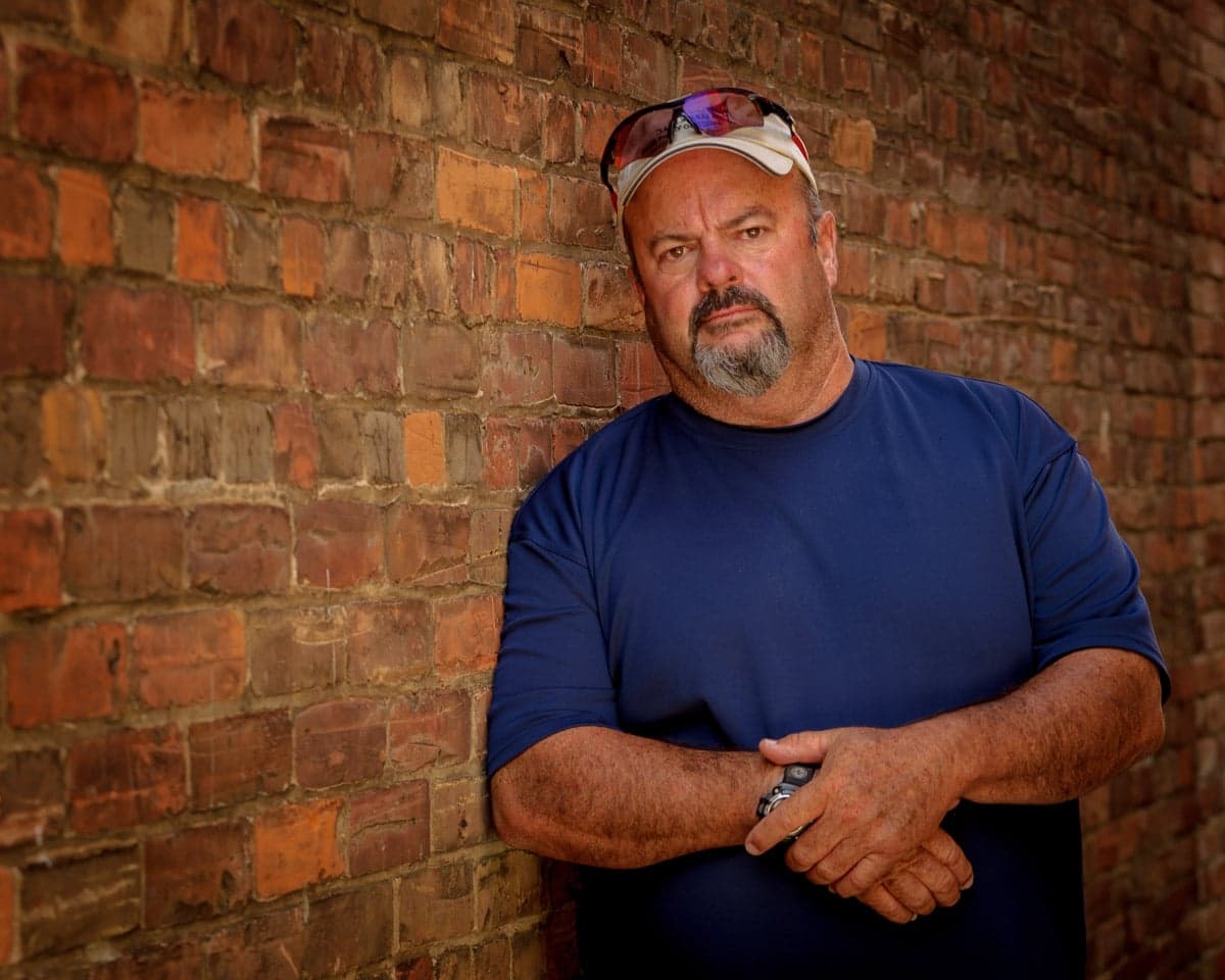 Pete Mather against a brick wall in Collingwood
